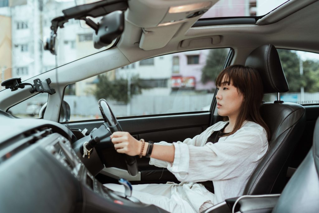 Women sitting in a fresh car thanks to the car odor eliminator